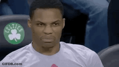 A Man Wearing A Celtics T-Shirt Is Sitting In The Stands Making A Funny Face . GIF