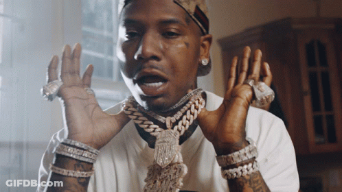 A Man Wearing A Chain Around His Neck And Many Bracelets GIF