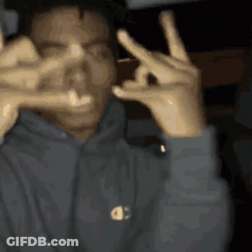 A Man Wearing A Champion Hoodie Making A Peace Sign With His Hands GIF
