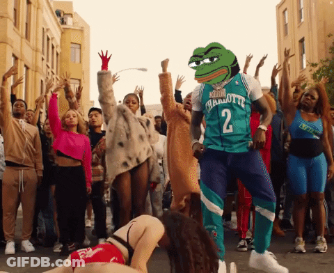 A Man Wearing A Charlotte 2 Jersey Is Dancing With A Crowd Of People GIF