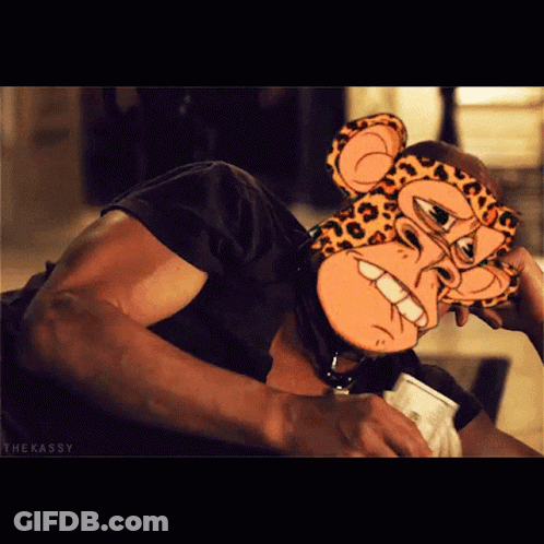A Man Wearing A Cheetah Mask Is Holding A Cup Of Coffee GIF