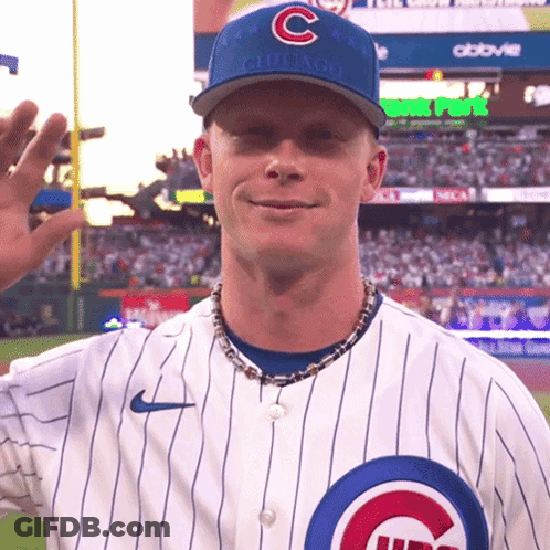 A Man Wearing A Chicago Cubs Hat Waves To The Crowd GIF