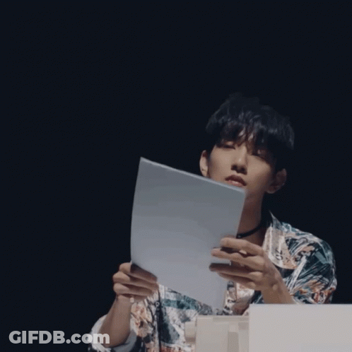 A Man Wearing A Choker And A Shirt With The Letter E On It GIF