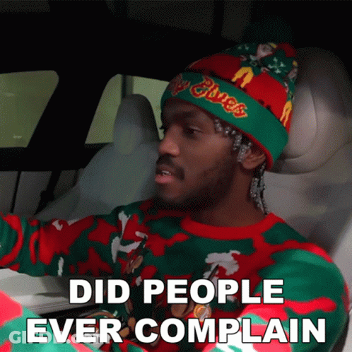 A Man Wearing A Christmas Sweater And A Beanie Says Did People Ever Complain GIF