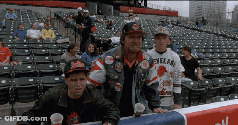 A Man Wearing A Cleveland Jersey Stands In A Crowded Stadium GIF