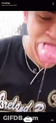 A Man Wearing A Cleveland Shirt Is Blowing Bubble Gum Out Of His Mouth GIF