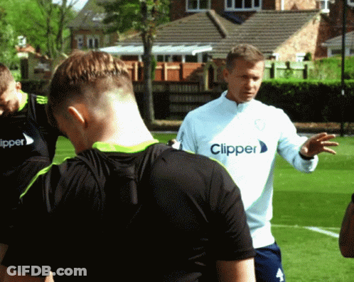 A Man Wearing A Clipper Shirt Talks To A Group Of Players GIF