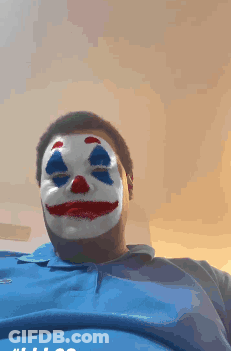 A Man Wearing A Clown Mask And A Blue Shirt GIF