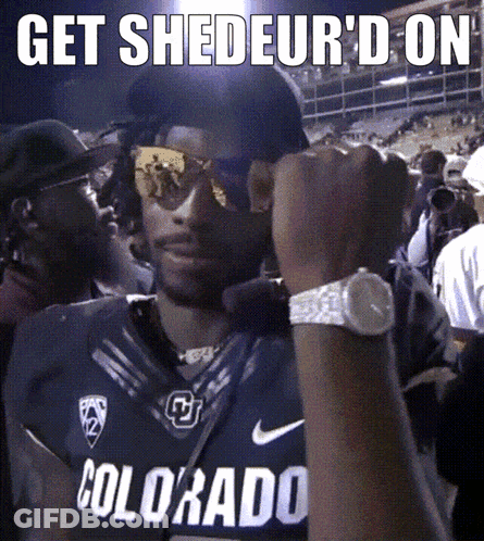 A Man Wearing A Colorado Jersey Holds His Fist In The Air GIF