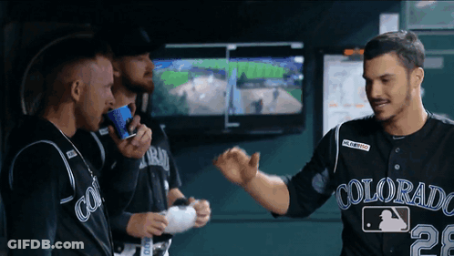 A Man Wearing A Colorado Jersey Is Talking To Another Man GIF