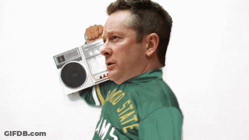A Man Wearing A Colorado State Rams Jacket Holds A Boombox GIF