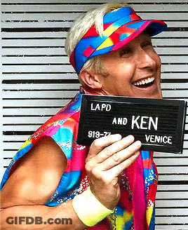 A Man Wearing A Colorful Hat And Holding A Sign That Says Lapd And Ken GIF