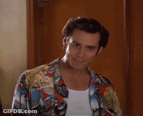 A Man Wearing A Colorful Shirt Is Smiling And Giving A High Five . GIF