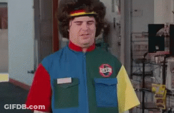 A Man Wearing A Colorful Shirt With A Nike Logo On It Is Standing In A Room . GIF
