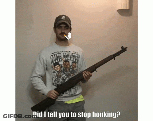A Man Wearing A Colts Country Shirt Holds A Rifle GIF