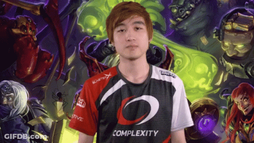 A Man Wearing A Complexity Shirt Is Standing In Front Of A Painting GIF