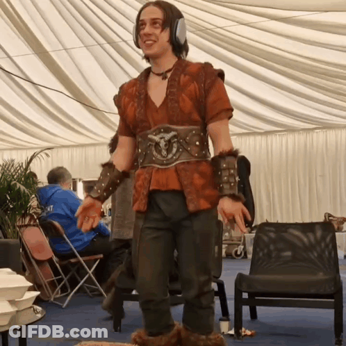 A Man Wearing A Costume With A Belt That Says ' Armour ' On It GIF