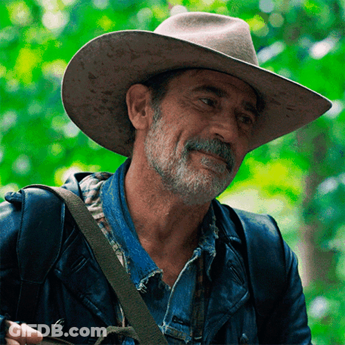 A Man Wearing A Cowboy Hat And A Denim Jacket GIF