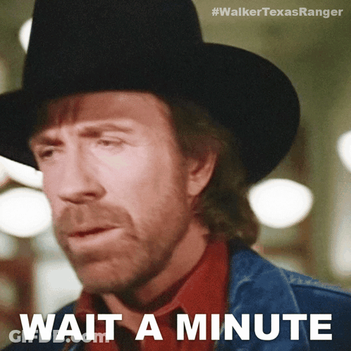 A Man Wearing A Cowboy Hat And A Denim Jacket Says " Wait A Minute " GIF