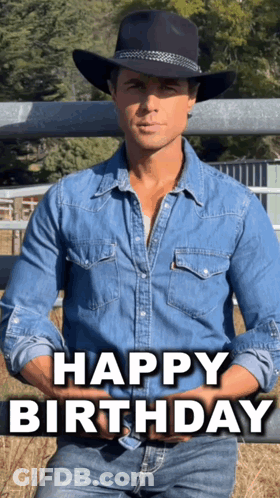 A Man Wearing A Cowboy Hat And A Denim Shirt Is Sitting In Front Of A Fence And Says Happy Birthday GIF