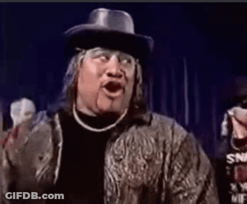 A Man Wearing A Cowboy Hat And A Jacket Is Making A Funny Face With His Mouth Open . GIF