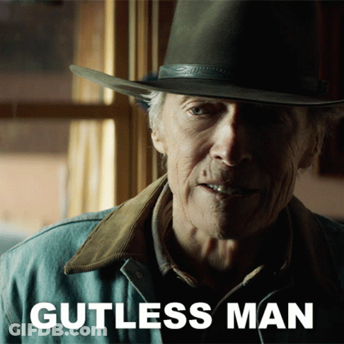 A Man Wearing A Cowboy Hat And A Jacket With Gutless Man Written On It GIF