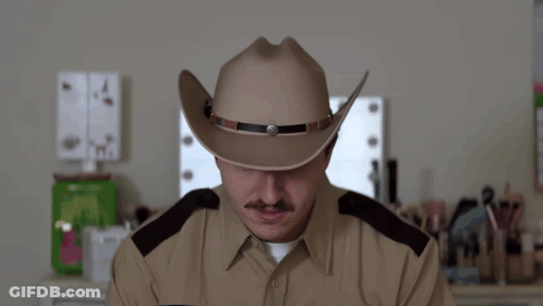 A Man Wearing A Cowboy Hat And A Police Uniform Says Thought GIF