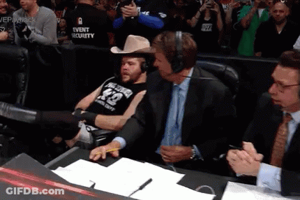 A Man Wearing A Cowboy Hat And A Shirt With The Number 42 On It Sits In A Chair GIF