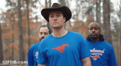 A Man Wearing A Cowboy Hat And A Wildwood Lective Shirt GIF
