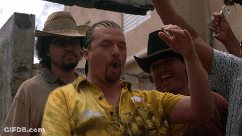 A Man Wearing A Cowboy Hat And A Yellow Shirt With The Letter Y On It GIF