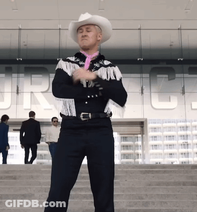 A Man Wearing A Cowboy Hat And Fringed Jacket Stands In Front Of A Building That Says Jrc GIF