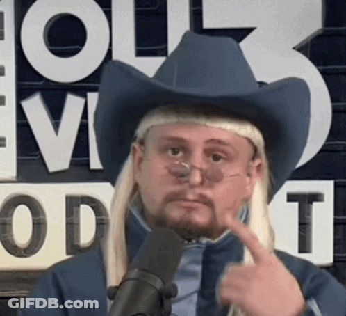 A Man Wearing A Cowboy Hat And Glasses Is Pointing To His Face . GIF