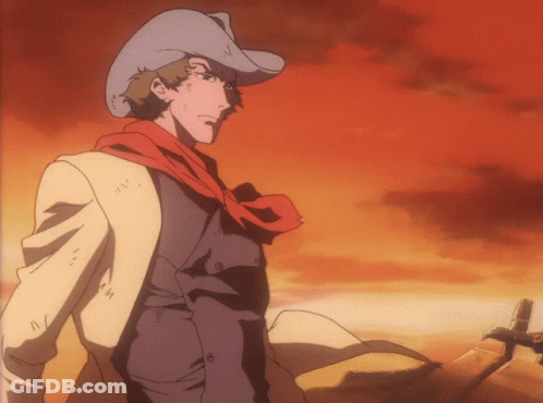A Man Wearing A Cowboy Hat And Scarf Is Standing In The Desert GIF