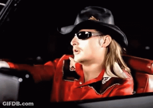A Man Wearing A Cowboy Hat And Sunglasses Is Sitting In A Car . GIF