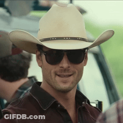 A Man Wearing A Cowboy Hat And Sunglasses Looks At The Camera GIF