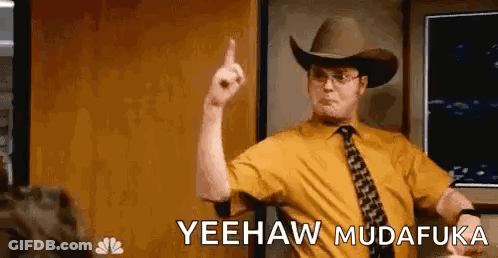 A Man Wearing A Cowboy Hat And Tie Is Pointing His Finger Up . GIF