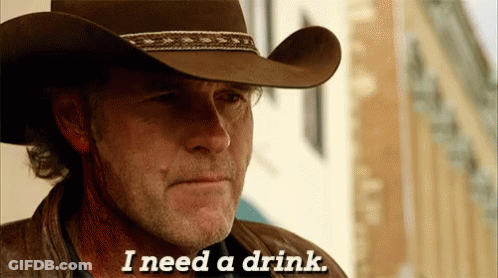 A Man Wearing A Cowboy Hat Is Saying I Need A Drink GIF