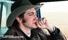 A Man Wearing A Cowboy Hat Is Smoking A Cigarette In A Car GIF