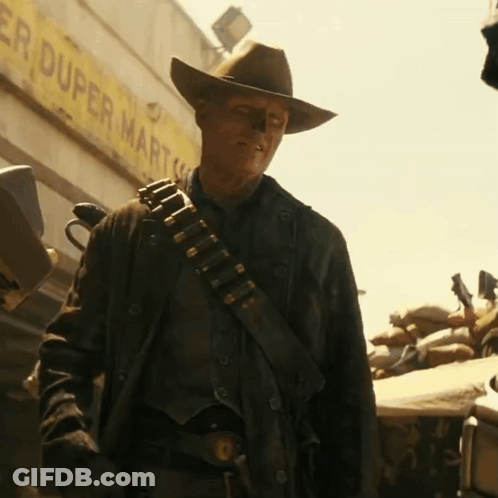 A Man Wearing A Cowboy Hat Is Standing In Front Of A Duper Mart GIF