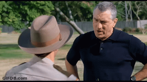 A Man Wearing A Cowboy Hat Is Talking To Another Man GIF