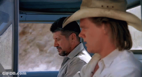 A Man Wearing A Cowboy Hat Sits Next To Another Man GIF