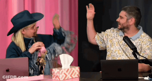 A Man Wearing A Cowboy Hat Talks Into A Microphone Next To A Box Of Tissues And An Apple Laptop GIF