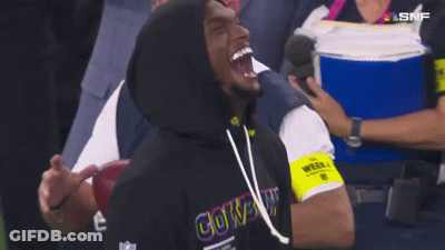A Man Wearing A Cowboys Hoodie Laughs While Watching A Football Game GIF