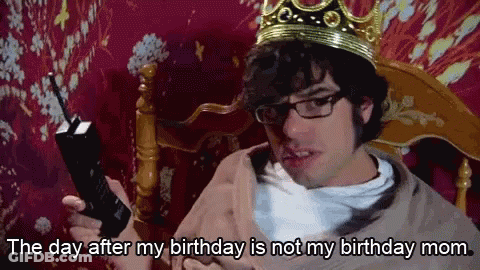 A Man Wearing A Crown And Glasses Is Holding A Cell Phone And Saying The Day After My Birthday Is Not My Birthday Mom GIF