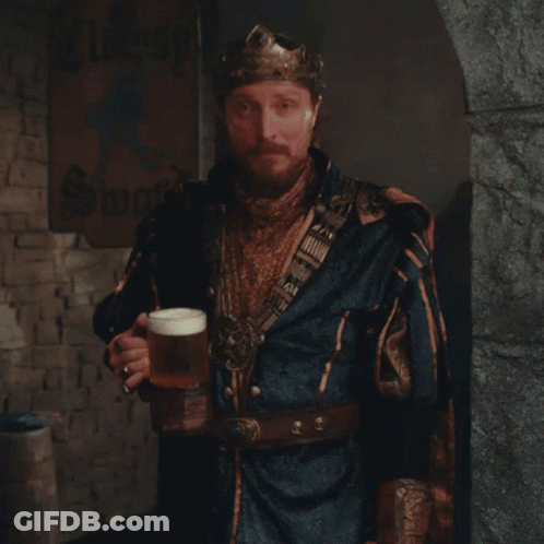A Man Wearing A Crown Holds A Glass Of Beer GIF