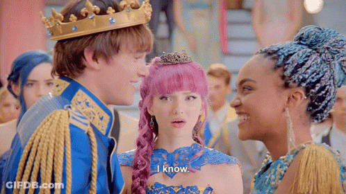 A Man Wearing A Crown Is Standing Next To A Woman With Pink Hair And A Girl With Blue Hair . GIF