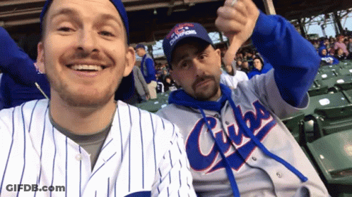 A Man Wearing A Cubs Jersey Gives A Thumbs Down Sign GIF