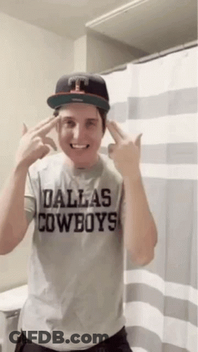 A Man Wearing A Dallas Cowboys Shirt And Hat GIF