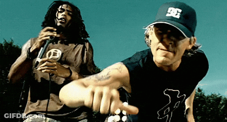 A Man Wearing A Dc Hat Is Pointing At Another Man GIF