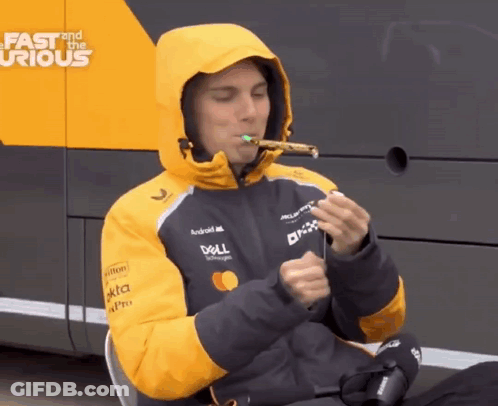 A Man Wearing A Dell Jacket Is Blowing A Party Horn GIF